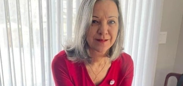 Person wearing red sweater indoors.