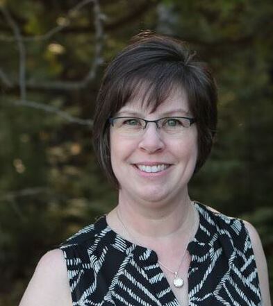 Woman in patterned top outdoors.