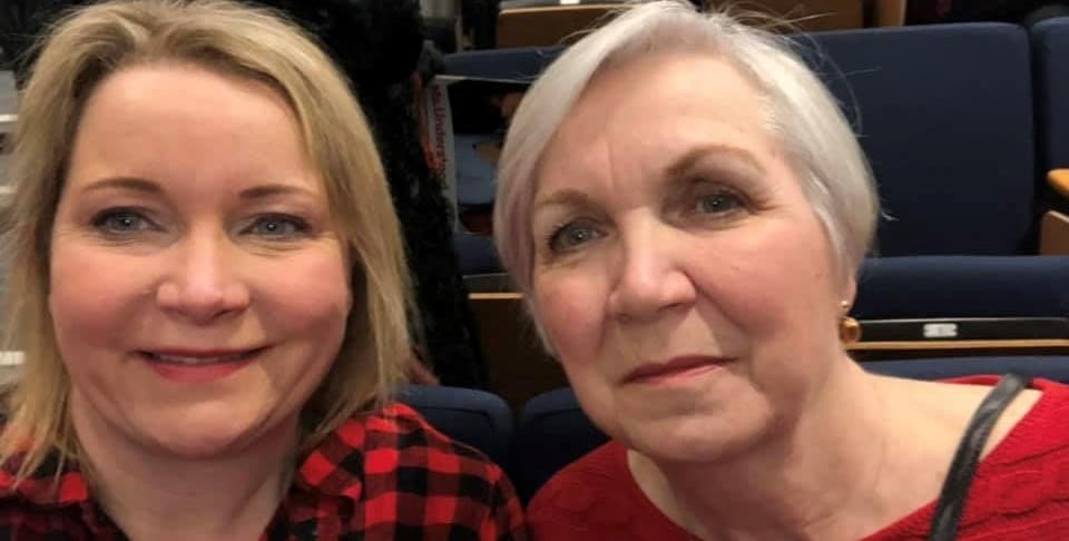 Two women in a theater setting.