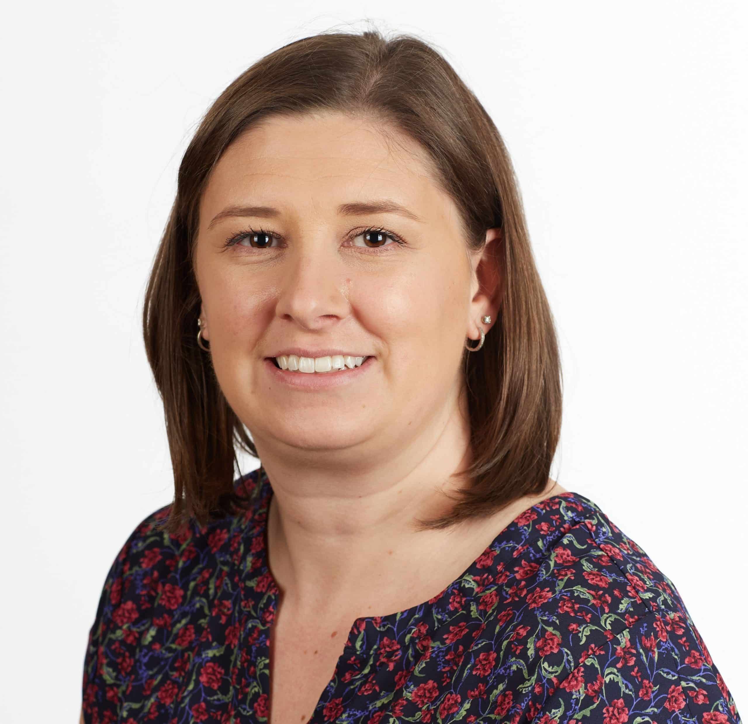 Woman in floral patterned blouse.