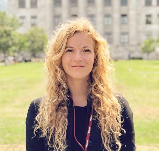 Person with long, wavy hair outdoors.