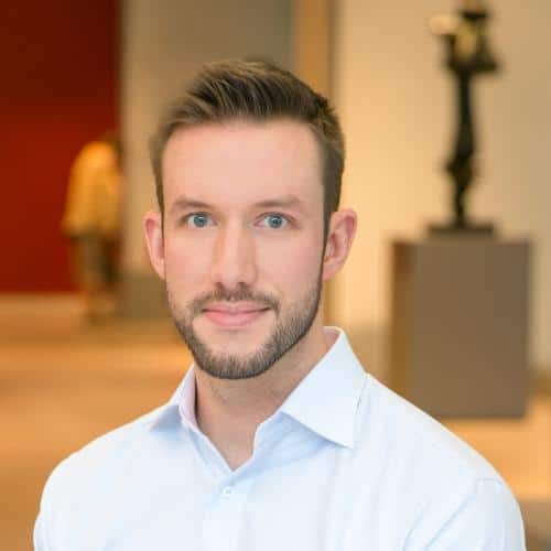 Indoor setting with sculpture in background.