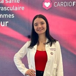 Woman in lab coat, red top.