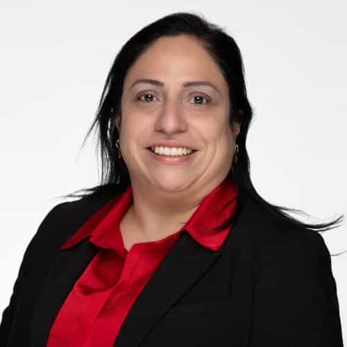 Woman in black suit, red shirt.