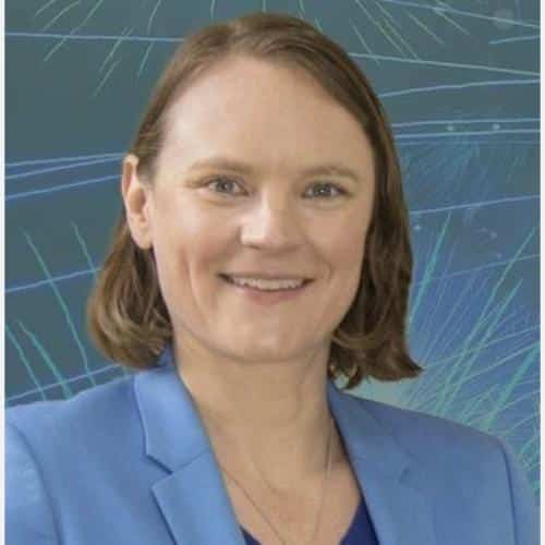 Person in blue blazer, abstract background.