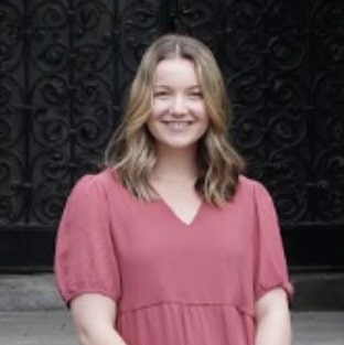 Person in pink dress outdoors.