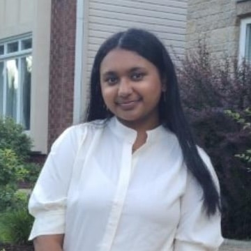 Person in white shirt outdoors.