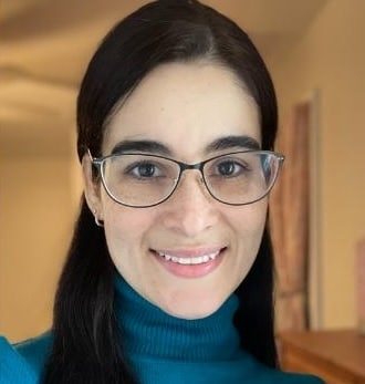 Person wearing glasses and sweater.