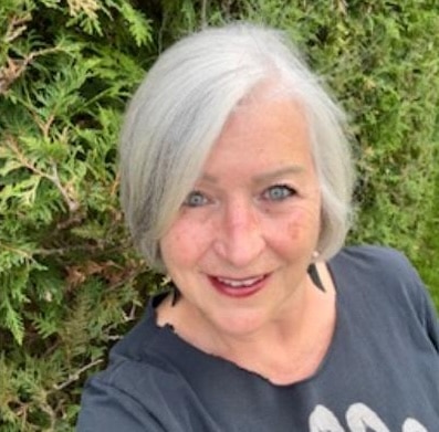 Person with gray hair outdoors