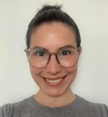 Person with dark hair and glasses