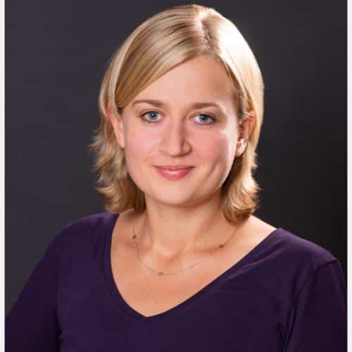 Woman with blonde hair, purple shirt.