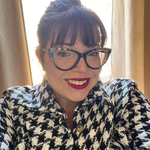 Person wearing a patterned jacket indoors.