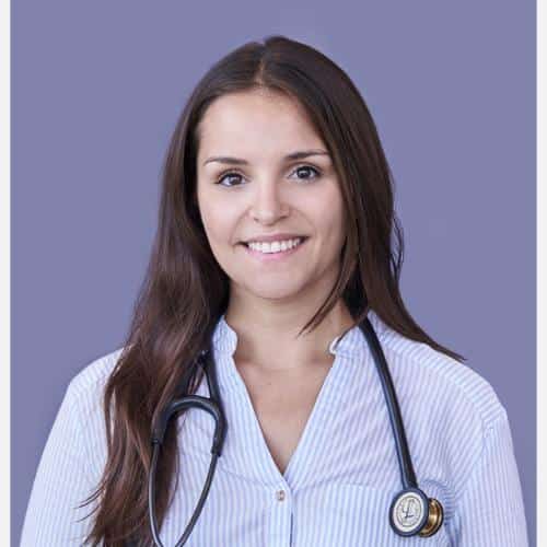 Person wearing a stethoscope, professional attire.
