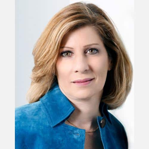 Woman with blonde hair, blue jacket.