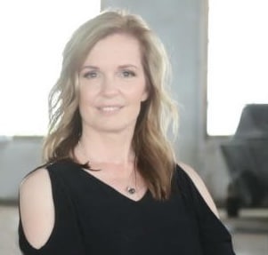 Woman in black top, indoor setting.