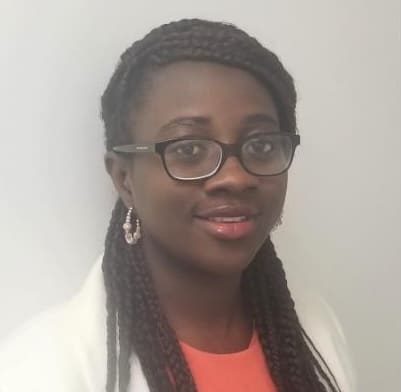 Person with braided hair and earrings.