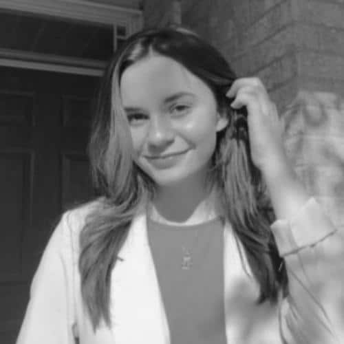 Woman adjusting hair outdoors.