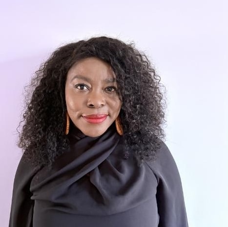 Person with curly hair, wearing black.