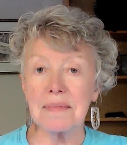 Person with curly hair, blue shirt.