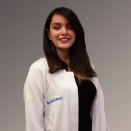 Person in a lab coat standing.